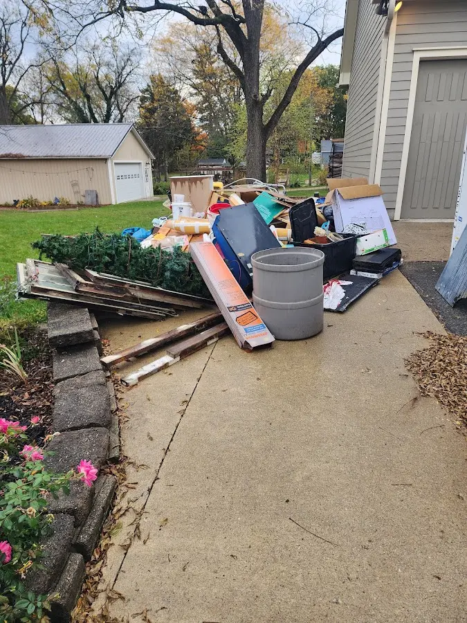 Dumpster being loaded with debris for Roofing Dumpster Rental in Kissimmee